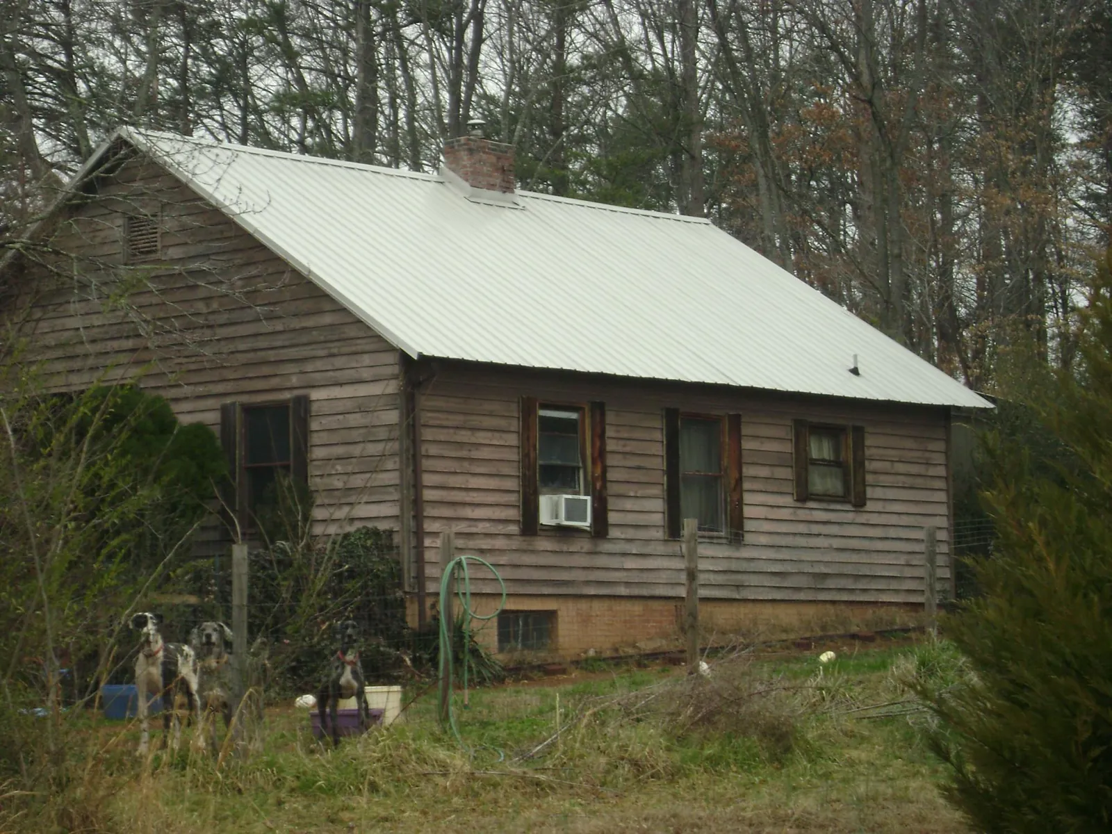 White metal roof on an old wood sided farmhouse, from a Asphalt Shingle Roof Repair job in Gardners